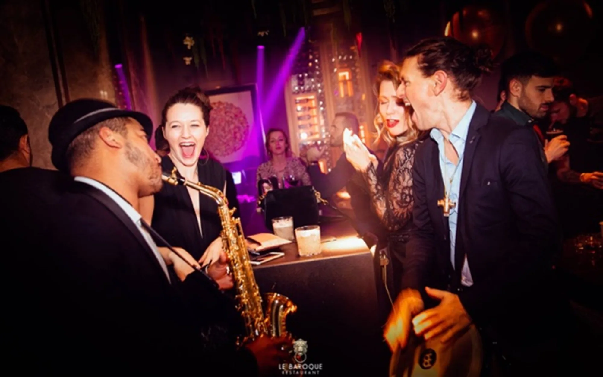 Invitée qui éclate de rire devant le saxophoniste